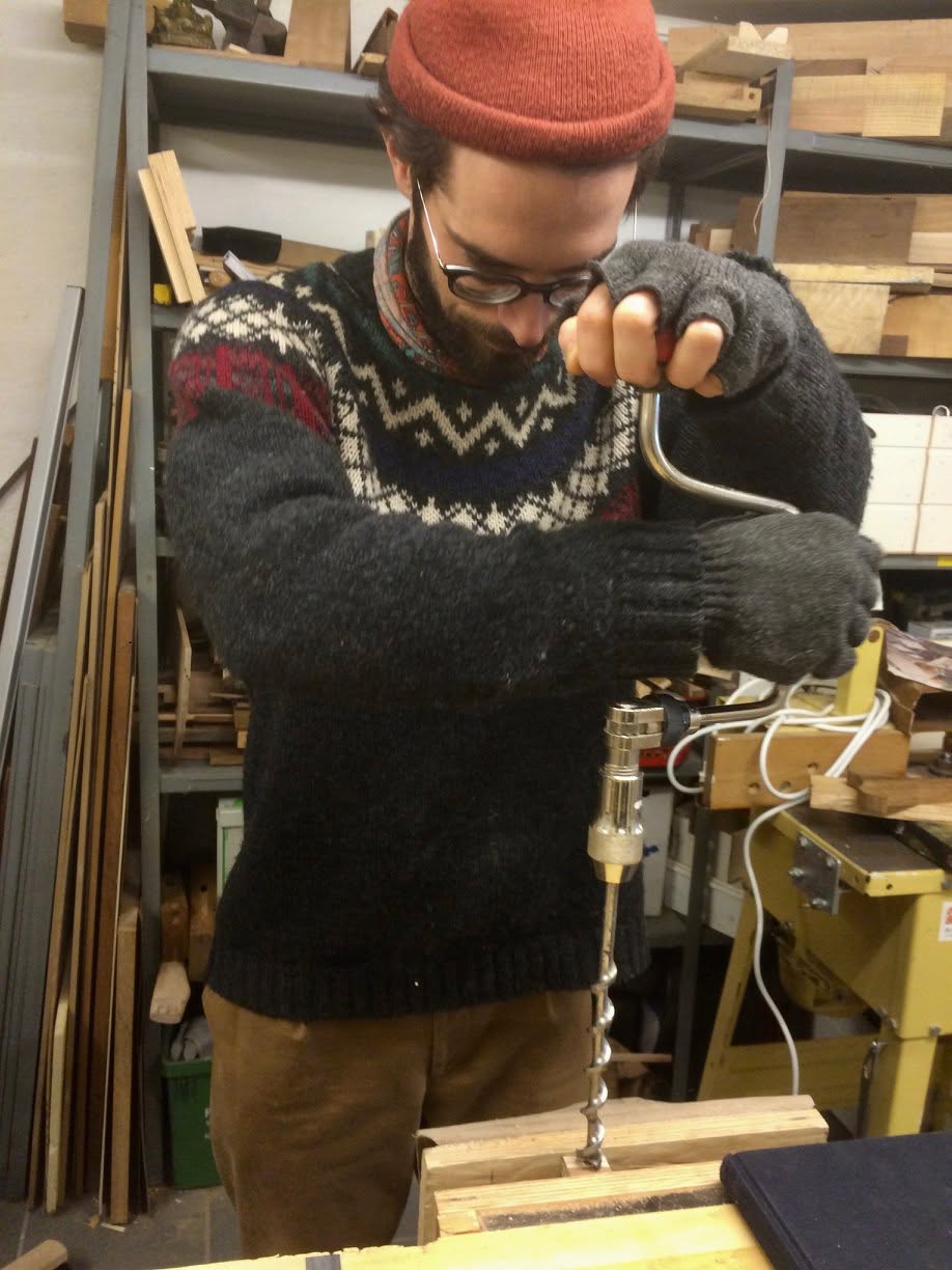 Zdenko drilling with a brace in the workshop in Porsgrunn